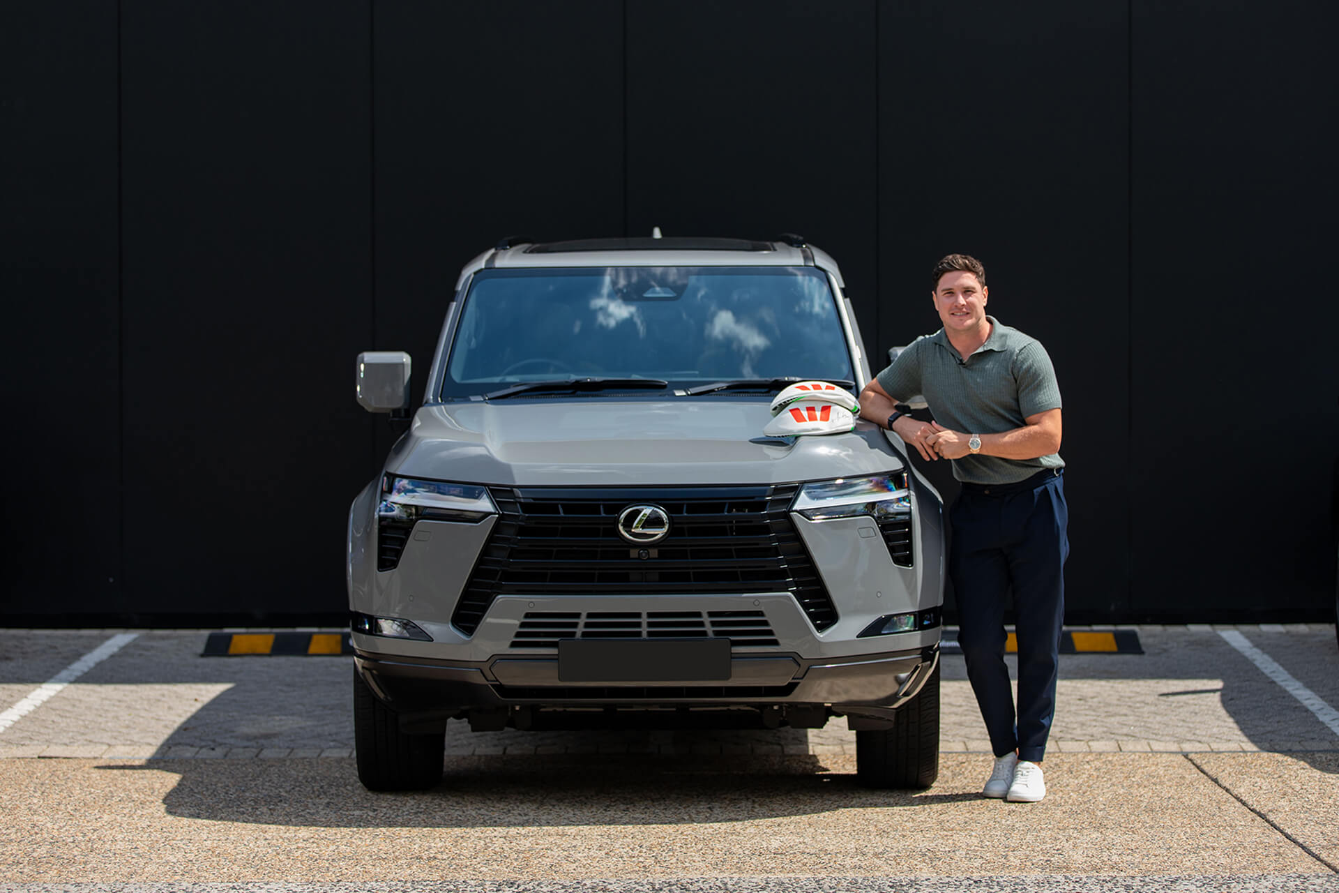 Mitch Moses next to a Lexus GX