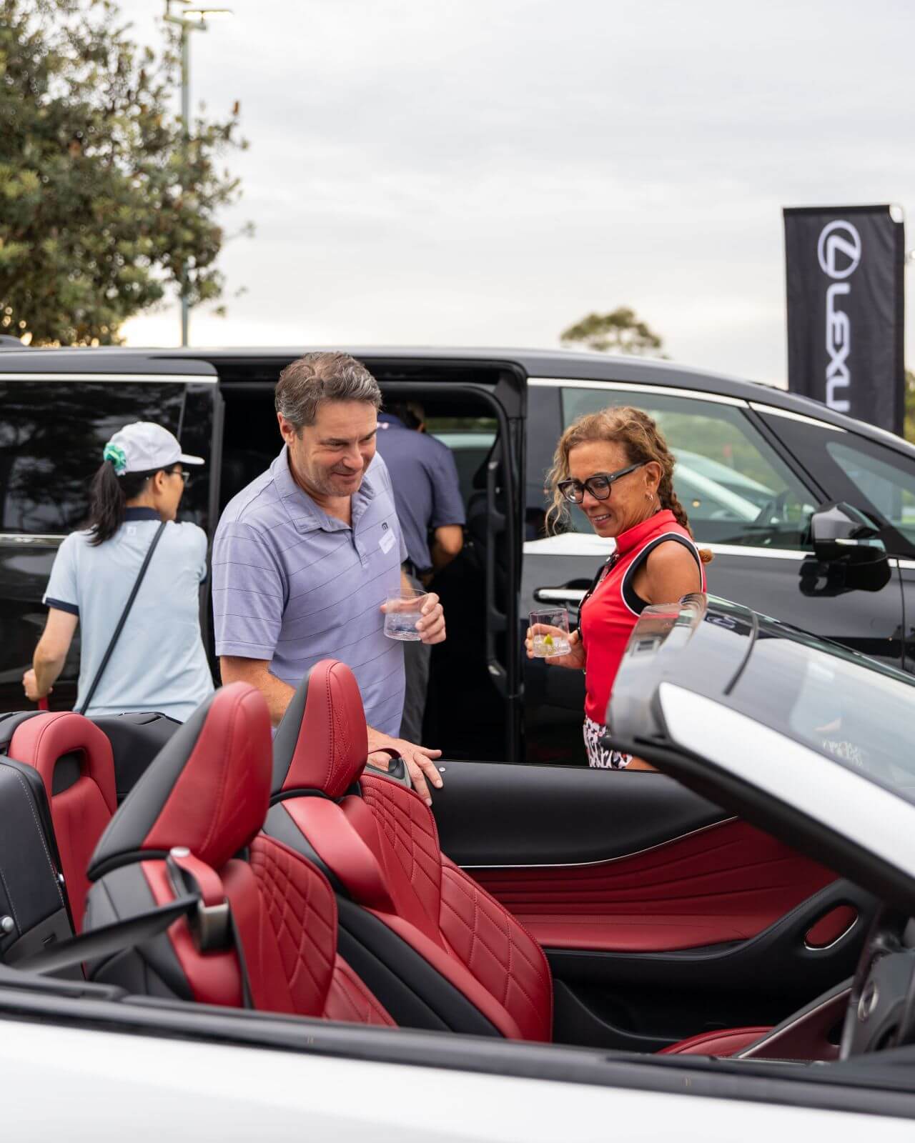Customers looking at Lexus vehicles at the Twilight Par 3 event