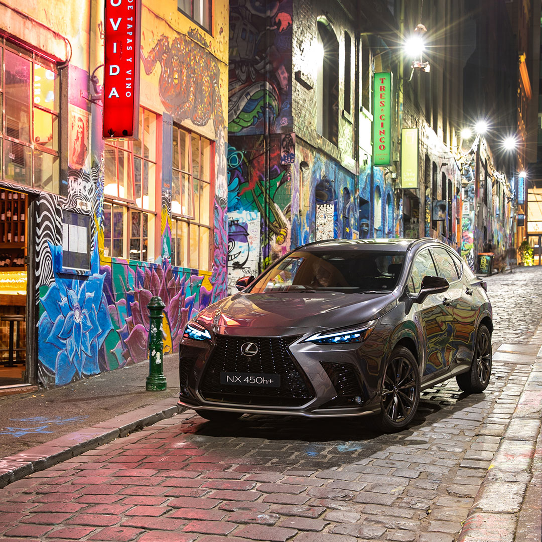 Lexus NX SUV parked in a graffiti street.