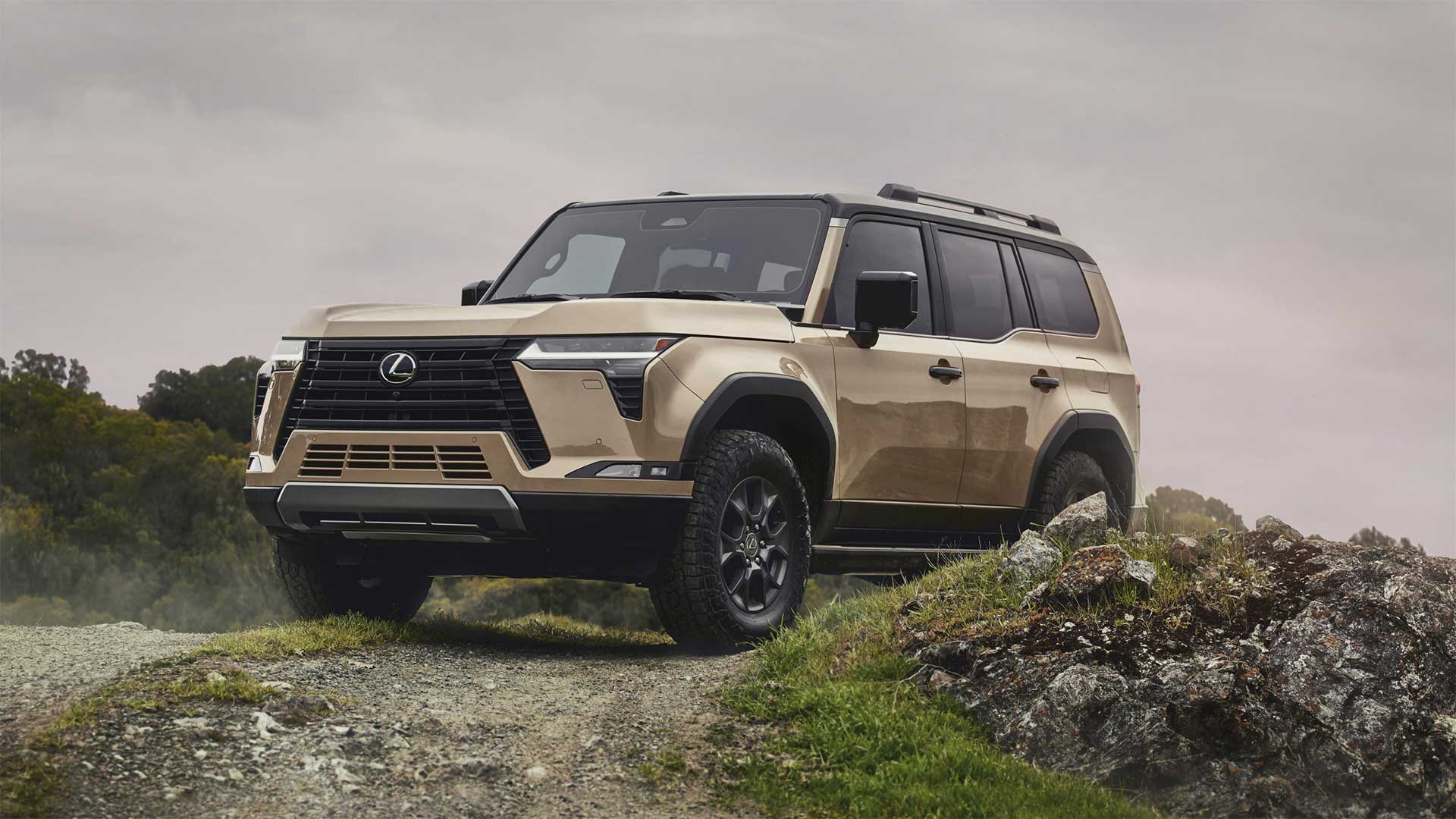 A Lexus GX is parked on the crest of a small hill.