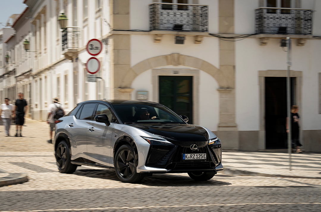 The Lexus RZ 550e F Sport driving on a street